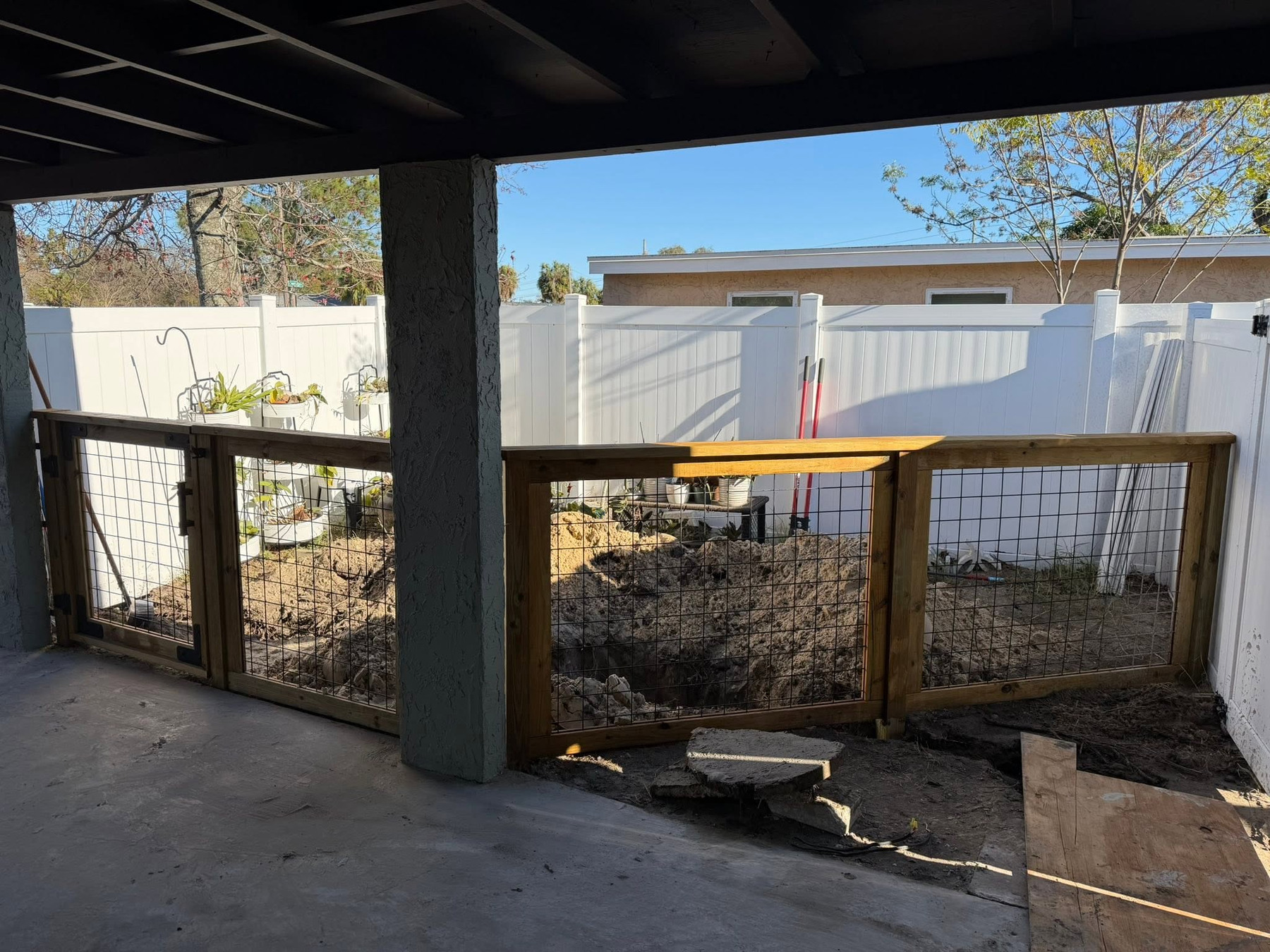 Wide view of the completed double gate across the covered patio opening