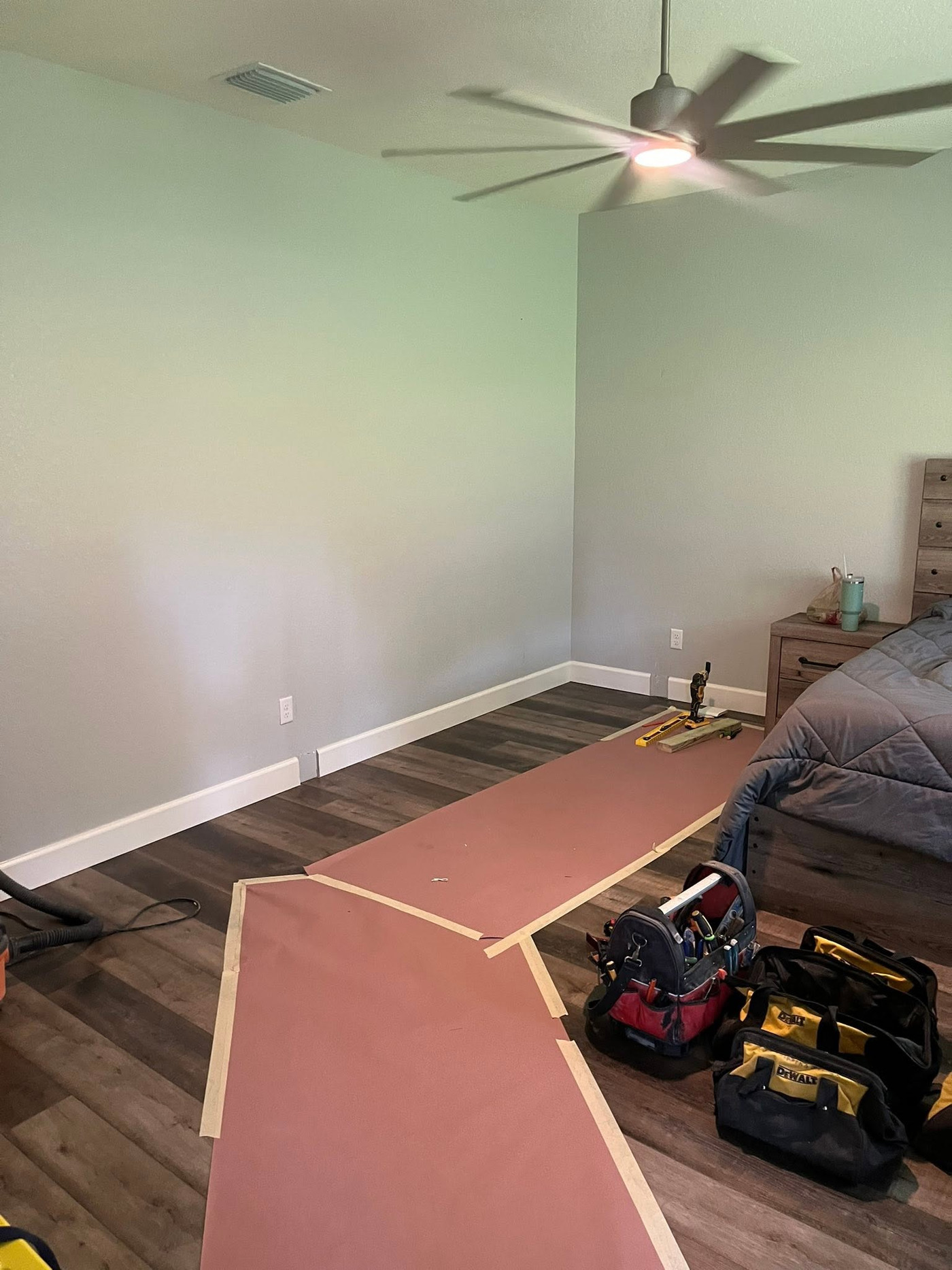 Bedroom wall and protected floor before the interior build-out